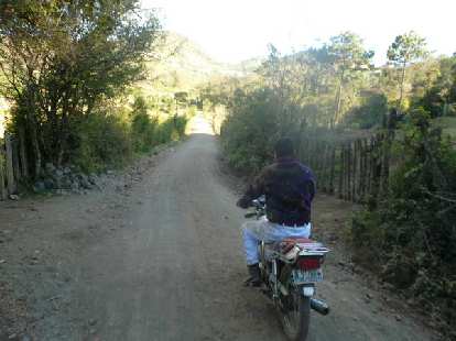Carlos on his Suzuki motorcycle on some backroads near San Andres Itzapa.  I road on the back and unfortunately we had just taken a spill before I took this photo.