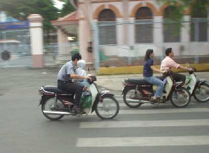 Motorbikers driving with babies in their lap is common in Vietnam!