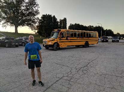Manuel with one of the yellow school buses that took runners to the start of the 2019 Wabash Trace Trail Marathon. Manuel with one of the yellow school buses that took runners to the start of the 2019 Wabash Trace Trail Marathon.