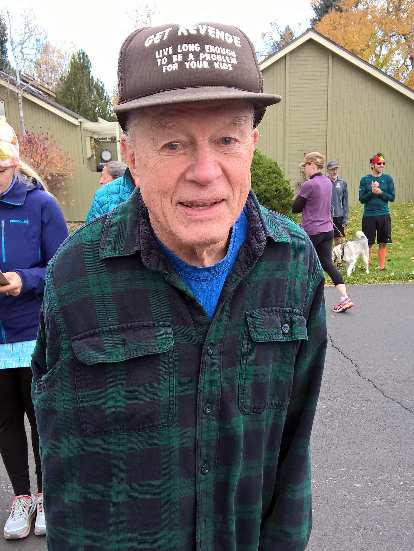 A runner wearing a comical hat that said, "Get Revenge: live long enough to be a problem for your kids." Photo: Old man, brown baseball cap, get revenge live long enough to be a problem for your kids