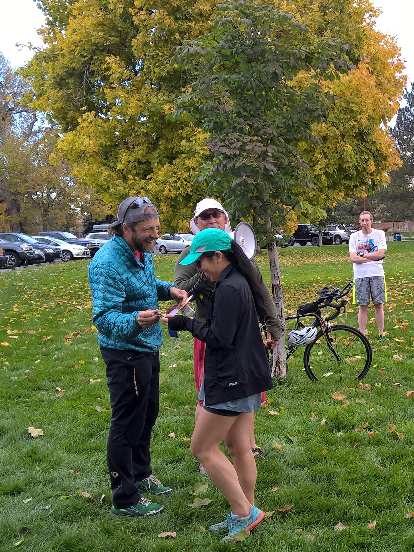 Nick awards the first place ribbon to Vanessa at the 2015 Warren Park 5k Tortoise &amp; Hare race.