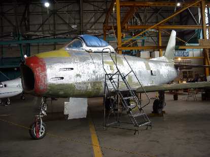 A plane under restoration inside the museum at the back.
