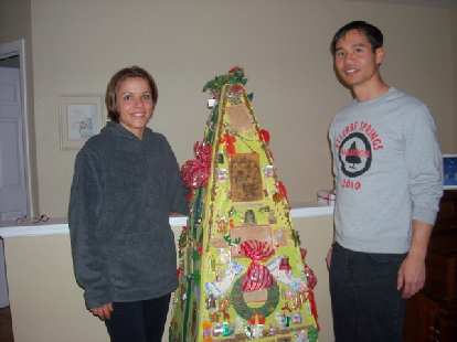Leah and Felix Wong by Dee's whatnot tree, which she created in 1973.
