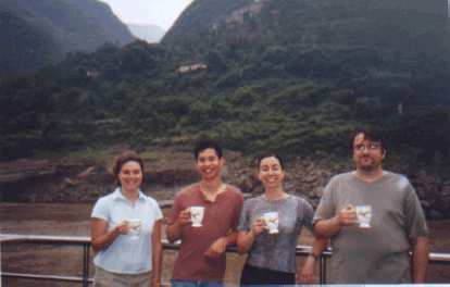 Karen, Felix, Martrese, and John drinking coffee or tea out of their "parting gifts". Photo: Martrese Beck. (31 May 2002) Karen, Felix, Martrese, and John drinking coffee or tea out of their "parting gifts".