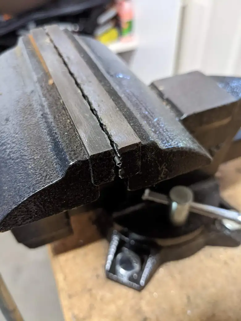 Here I inserted the outer cylinder of a spare watch pin into a vise...