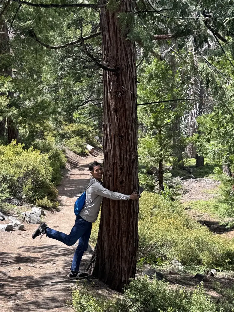 Hugging a tree.