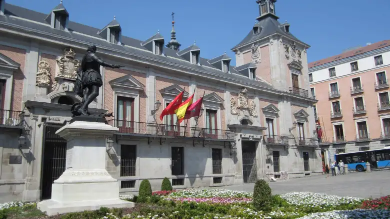 A statue and flags off Calle Mayor, west of la Plaza Mayor. A statue and flags off Calle Mayor, west of la Plaza Mayor.