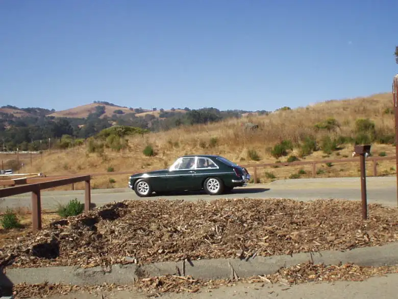 A dark green MGB GT following.