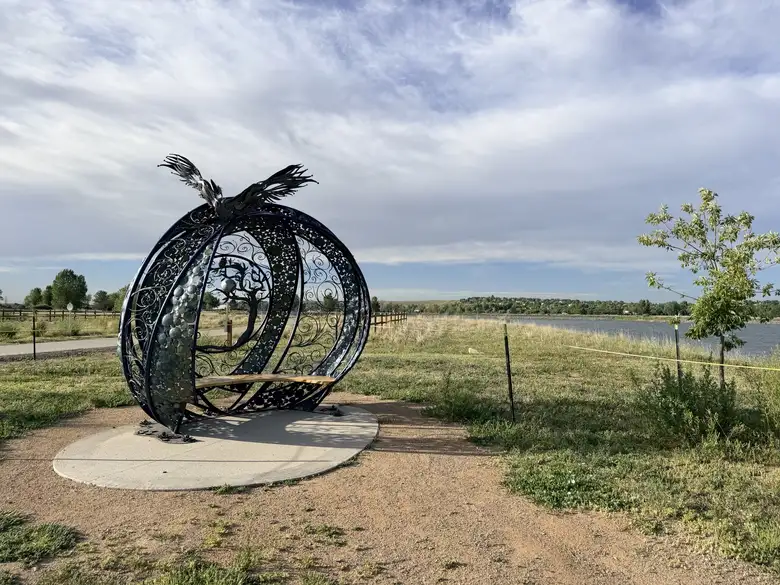 An steel sculpture housing a bench at River Bluffs Open Space.