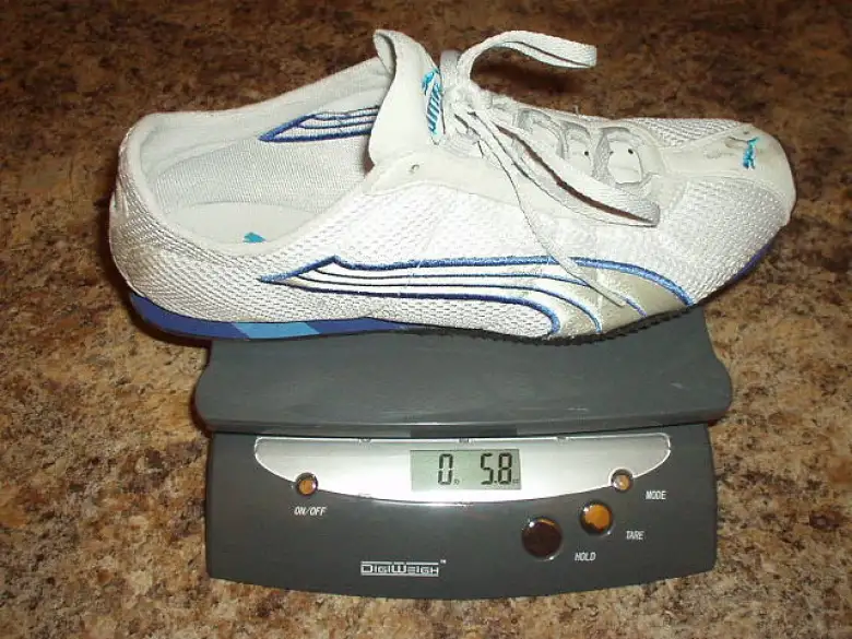 white and blue Puma H-Street shoe on postal scale reading 5.8 ounces
