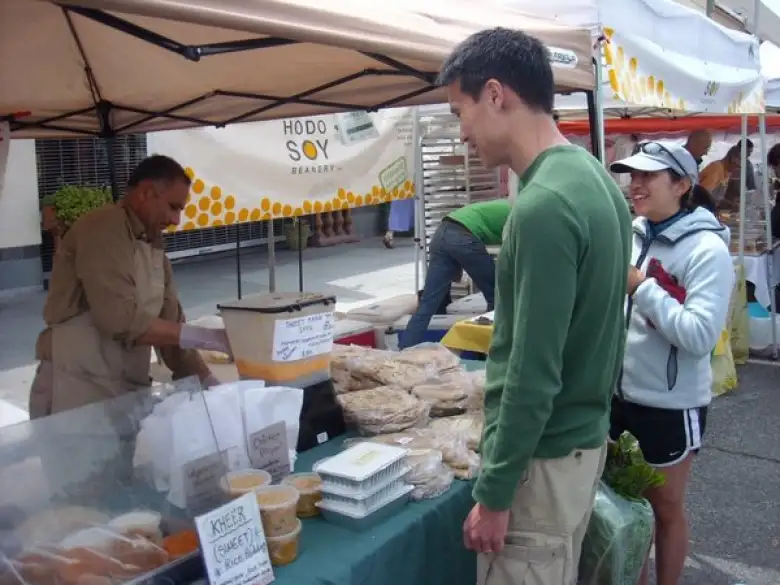 Having sweet mango lassis at the Palo Alto Farmers' Market.