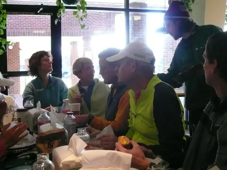 Jen Sajbel, Cathy Morgan, unknown person, Tom Schipper, Nick Clark, and unknown person sitting around a table