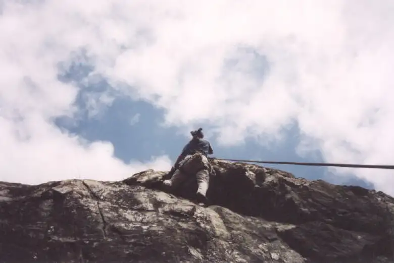 Tori rapelling down from the sky after setting up anchors for us.