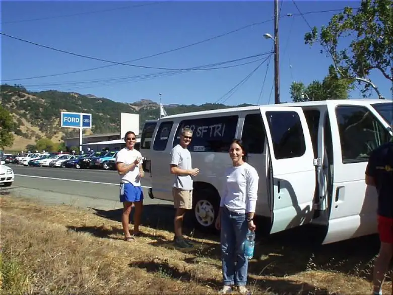[4 minutes before the start, 12:26 p.m.] Meanwhile, as luck would have it, we ran into Terry (Lisa's boyfriend), who was doing the race with the SF Tri Club.  Here's Lisa in front, with Terry and another dude in the background marking up their van.