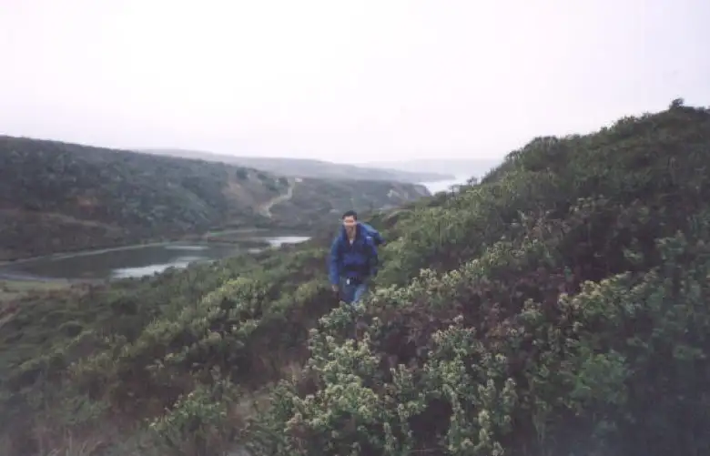 [Point Reyes, Nov 2001] Felix Wong charging dwn the trail in crazy-rain weather.