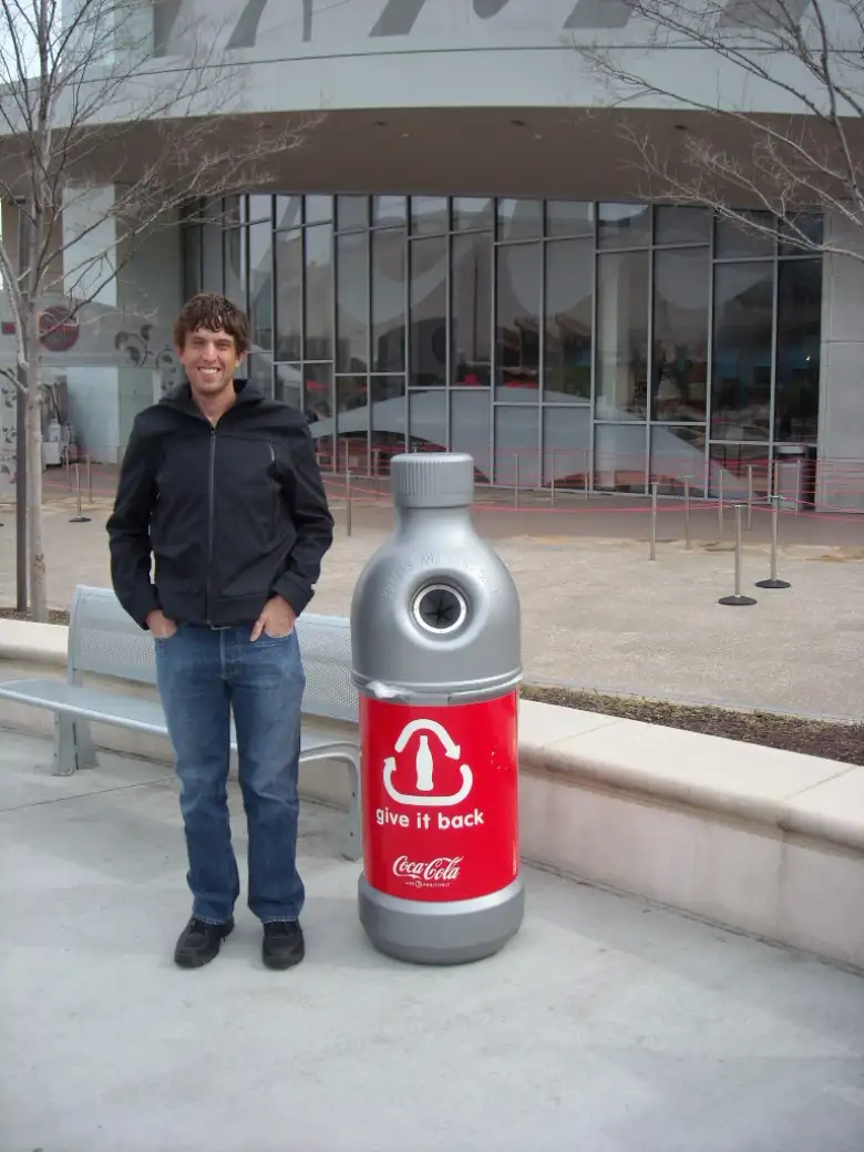 Dan next to a bottle-shapped recycling repository. Dan next to a bottle-shapped recycling repository.