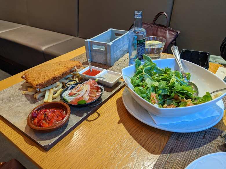 Enjoying a cachopín with fries and a salad at La Cantina Sixtina.