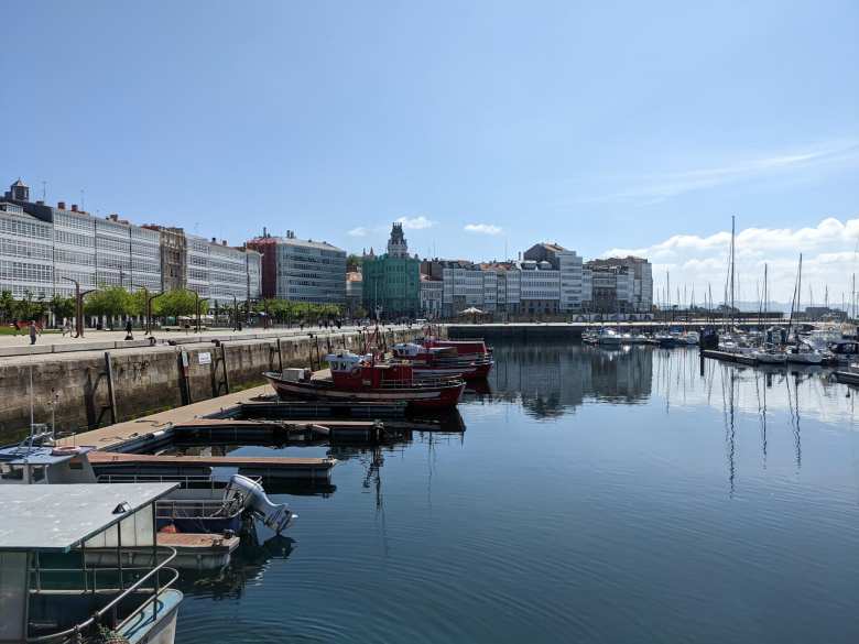 Buildings and ships by the harbor in A Coruña.