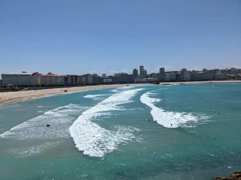 Surfers catching some waves by Playa de Matedero.