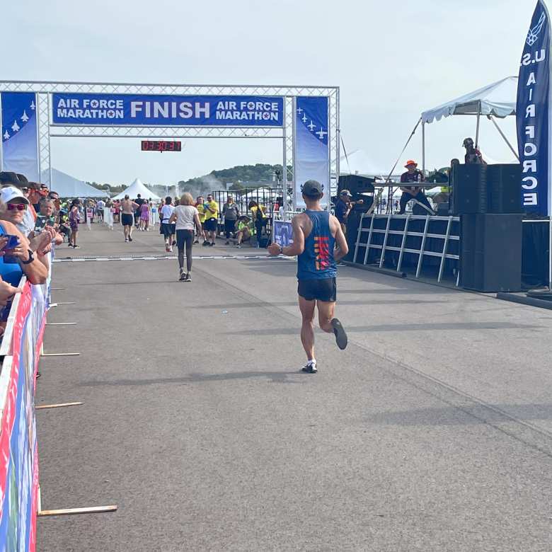 Felix Wong running towards the finish line of the 2022 Air Force Marathon.