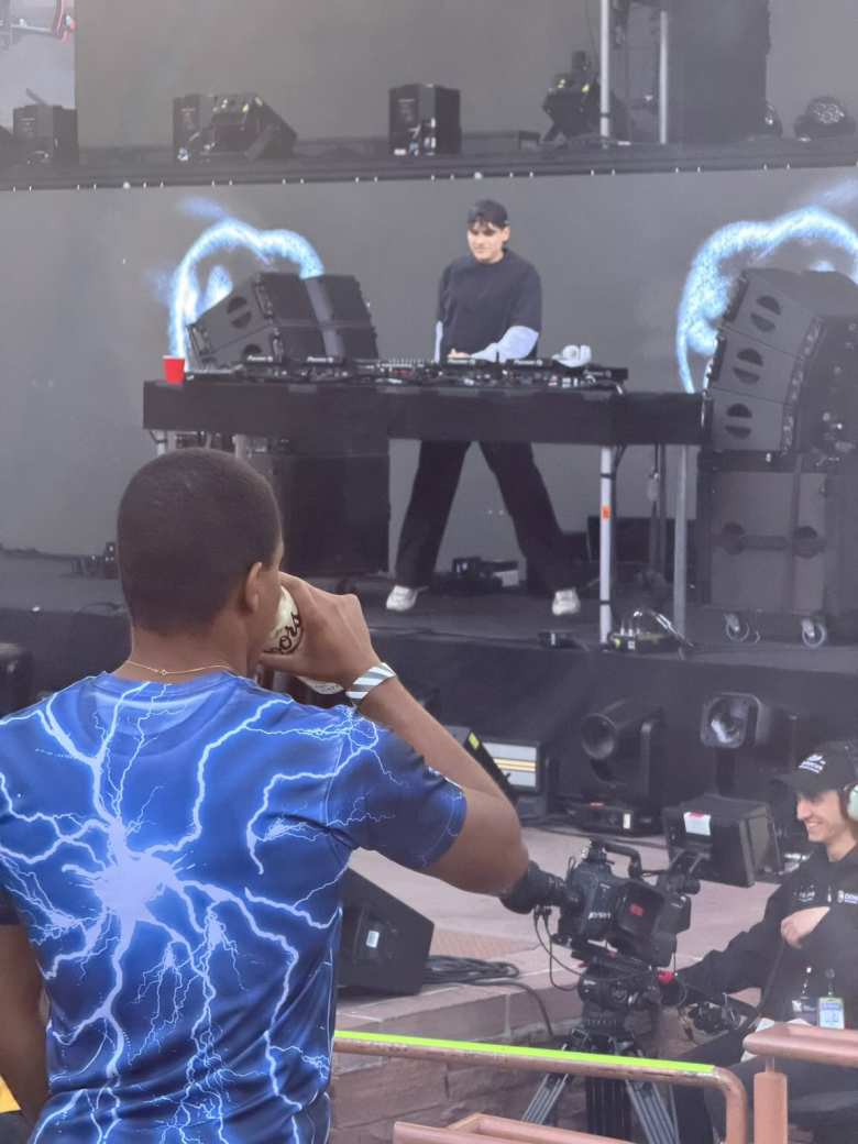 A young man drinks a Coors (presumably brewed in the factory in nearby Golden) as Audien plays a set.