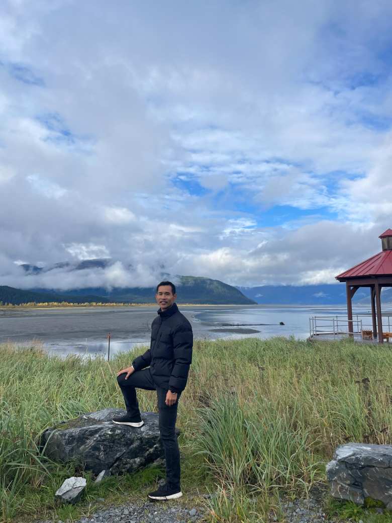 Felix Wong at the Alaska Wildlife Conservation Center, in front of the Turnagain Arm waterway.
