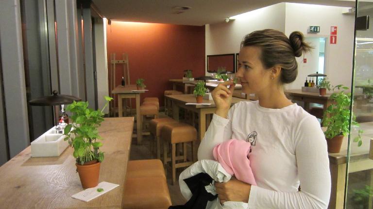 Katia enjoying the smell of basil in Vapiano.