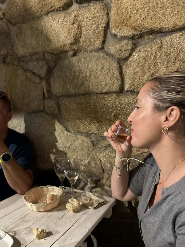 Andrea drinking the chupito (shot) of orujo that is customarily given at the end of dinner at Taberna Kamelia in Pontevedra.