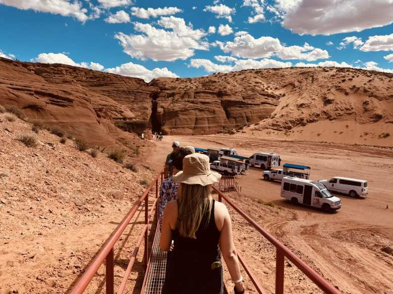 Andrea and other tourists walking on a bridge back towards the buses that brought us here.