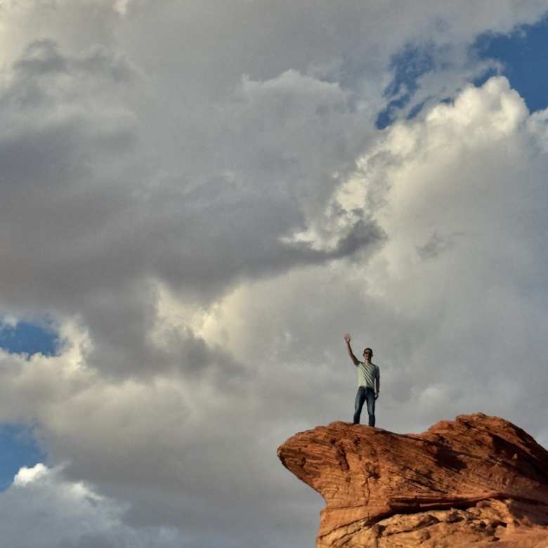 Felix on a tall rock formation at Horseshoe Bend, with lots of clouds above. Felix on a tall rock formation at Horseshoe Bend, with lots of clouds above.