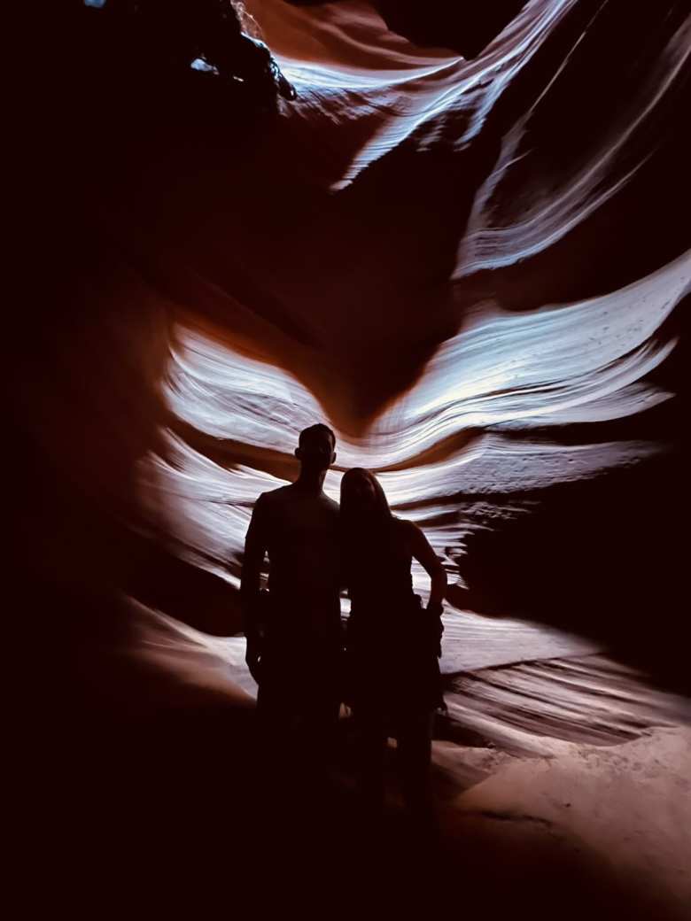 Felix and Andrea with angel wings cast by natural sunlight in Upper Antelope Canyon.