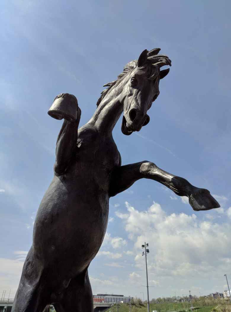 A large charcoal statue of a bronco at Mile High Stadium.
