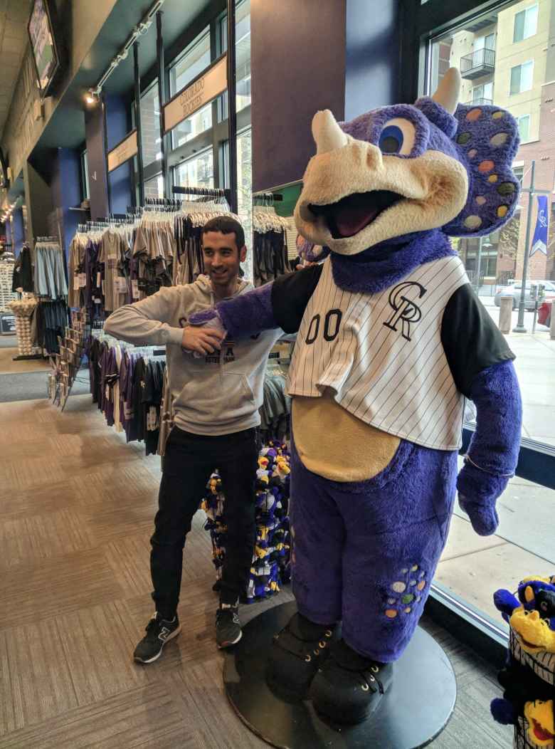 Antxon with a large stuffed animal version of the Colorado Rockies mascot.