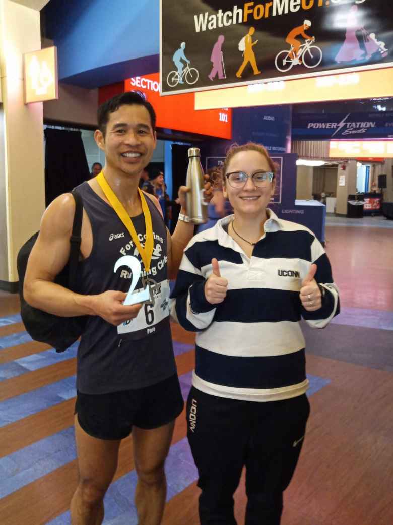 Felix Wong with a volunteer from the UConn lacrosse team, who filled his 16 ounce water bottle with Heed at least 5X!