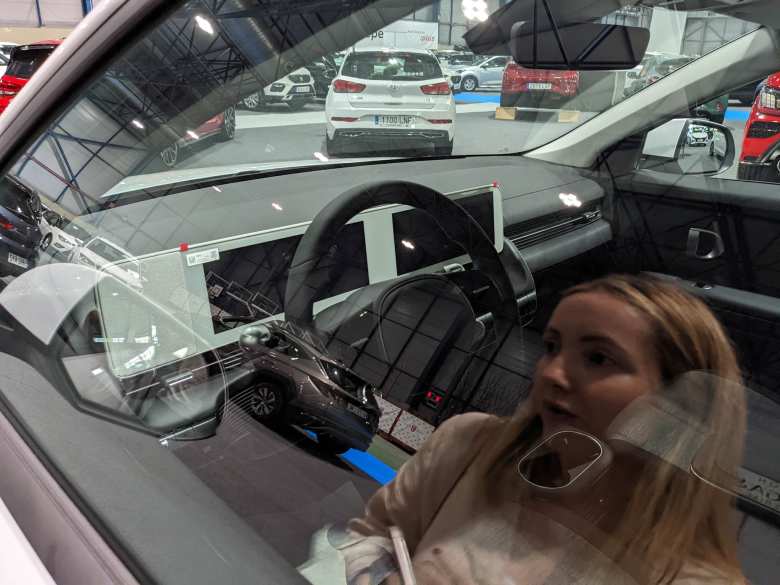 The interior of the Hyundai Ioniq 5, with Andrea in the reflection.