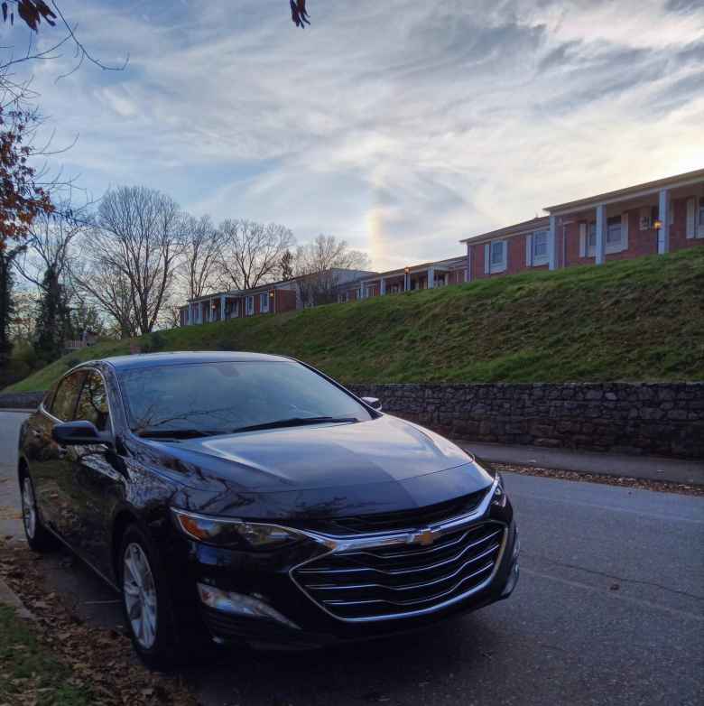A black 2020 Chevrolet Malibu in front of Maureen's old living quarters.