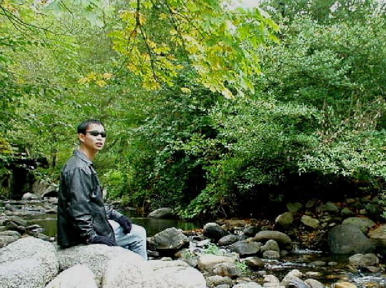 Felix Wong in front of a creek passing through Lithia Park.