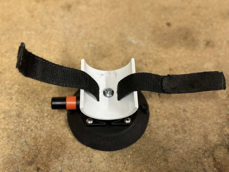 I then created a center hole in the PVC wheel base to attach to a Seasucker suction cup with a screw. I used a drill to create grooves in the PVC base to allow a velcro ankle strap to slide through. I later put a piece of electric tape on top to prevent the screw head from rubbing a hole in the bicycle tire.
