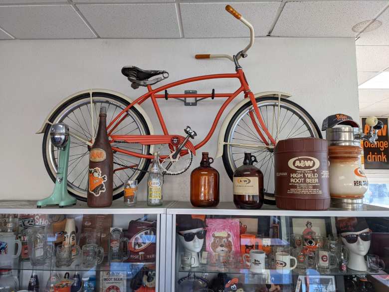 An orange cruiser bike along with other A&W memorabilia inside the A&W restaurant in Lodi, California.