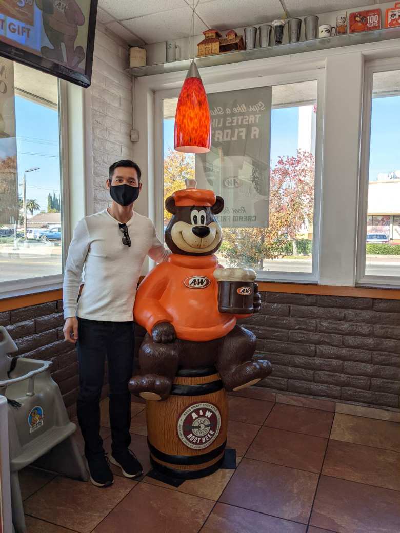 Felix with the A&W Great Root Bear mascot inside A&W Restaurant in Lodi, California.