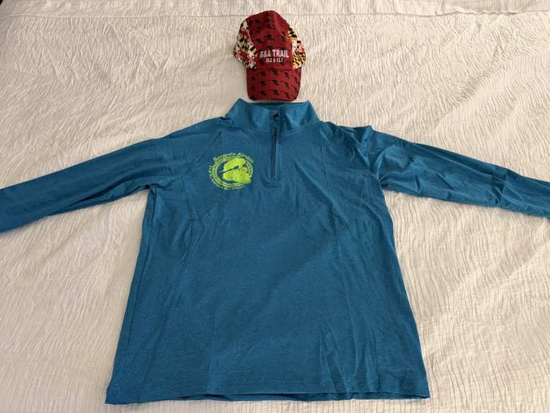 The schwag for the B&A Trail Marathon was genuinely the highest quality of any race schwag I've ever received. They included a Frank Shorter quarter-zip and a technical running hat. Both were procured from the National Running Center.