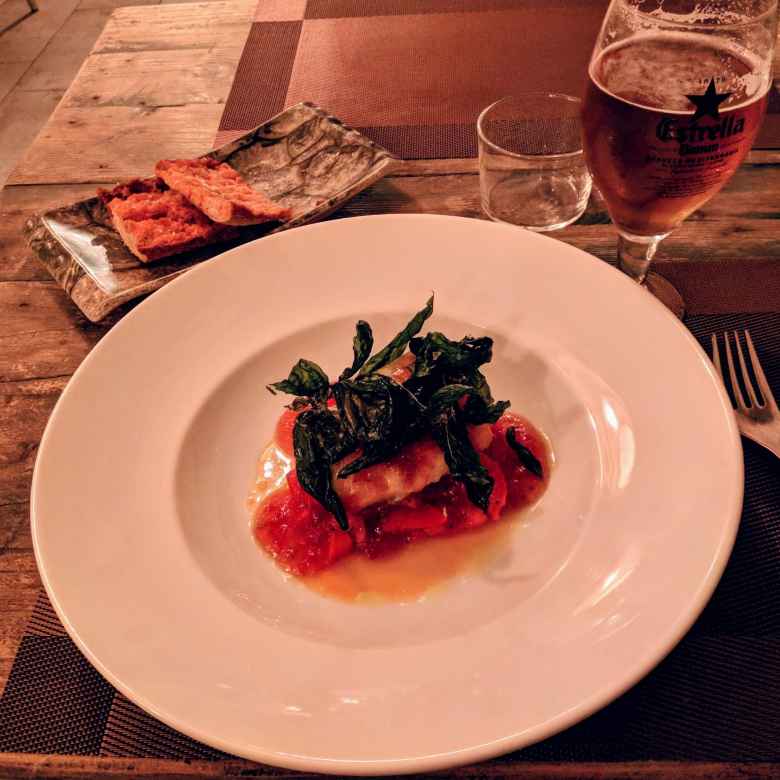 Pan con tomate (bread with tomato), bacalao (codfish), and an Estrella beer at the excellent 4 Plats i Punt restaurant.