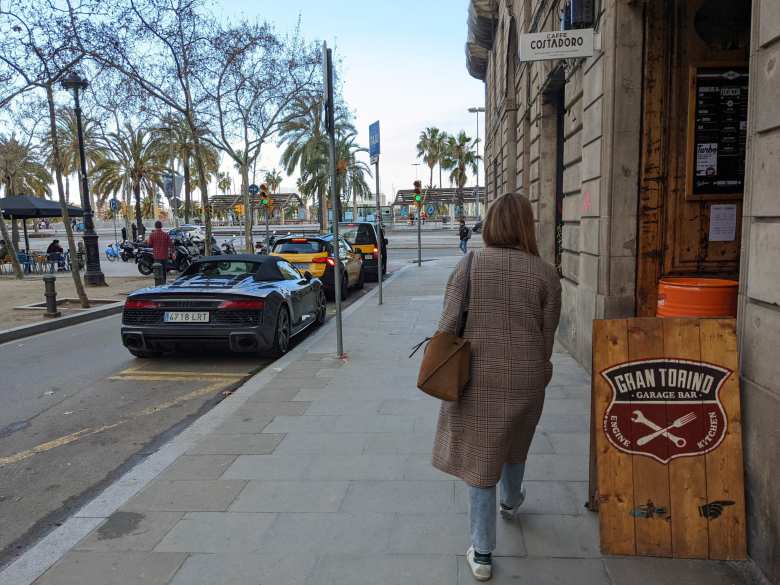 A black Audi R8 convertible and Andrea outside the Gran Torino Garage Bar in Barcelona.