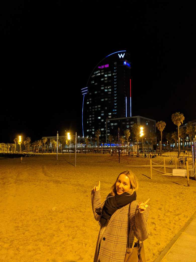 Andrea at the beach in front of the W Barcelona at night.
