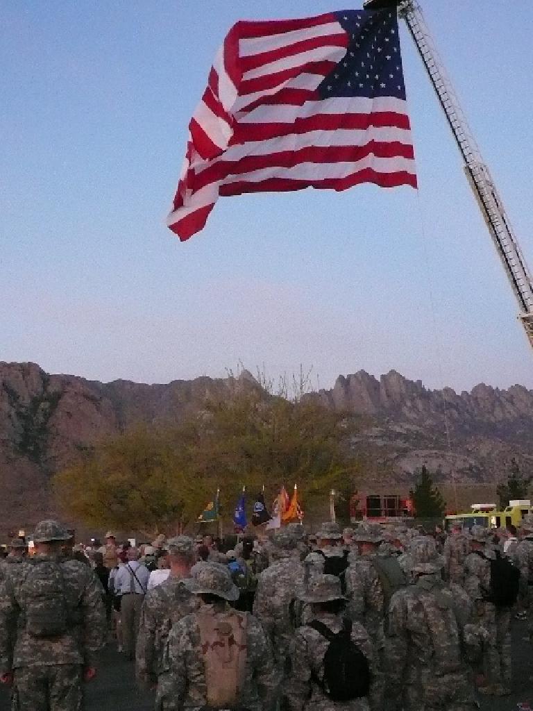 A huge U.S. flag flew above the many military participants here. A huge U.S. flag flew above the many military participants here.