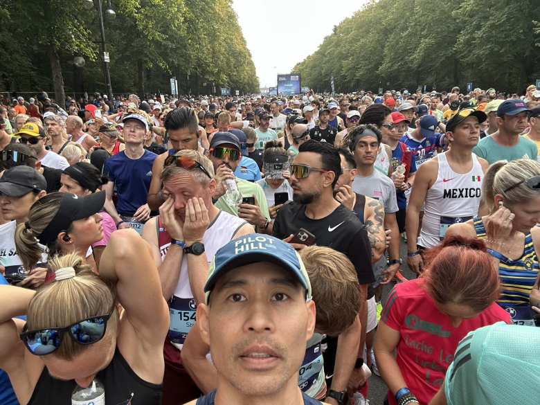 blue Dixi portable toilet depicting a man with crossed legs and a woman covering her groin with her hands