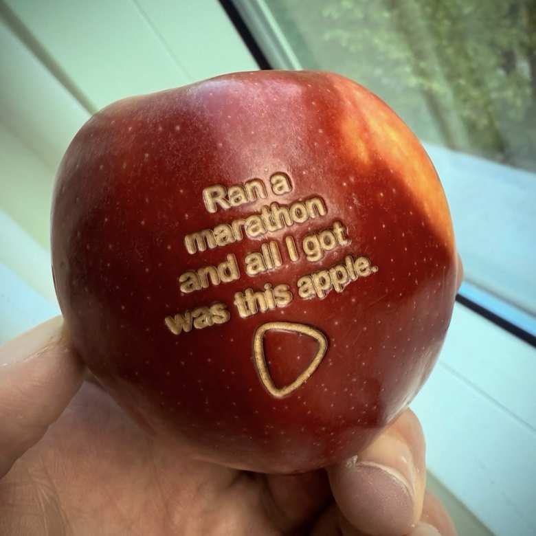 A red apple with words carved into it