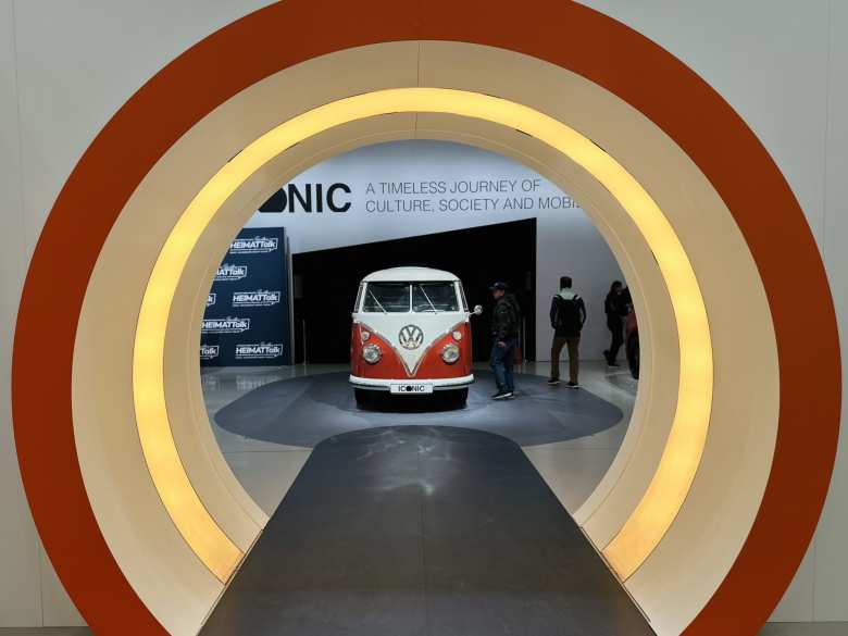 An red and white Volkswagen Bus at the ICONIC exhibition inside the DRIVE Volkswagen Group Forum.