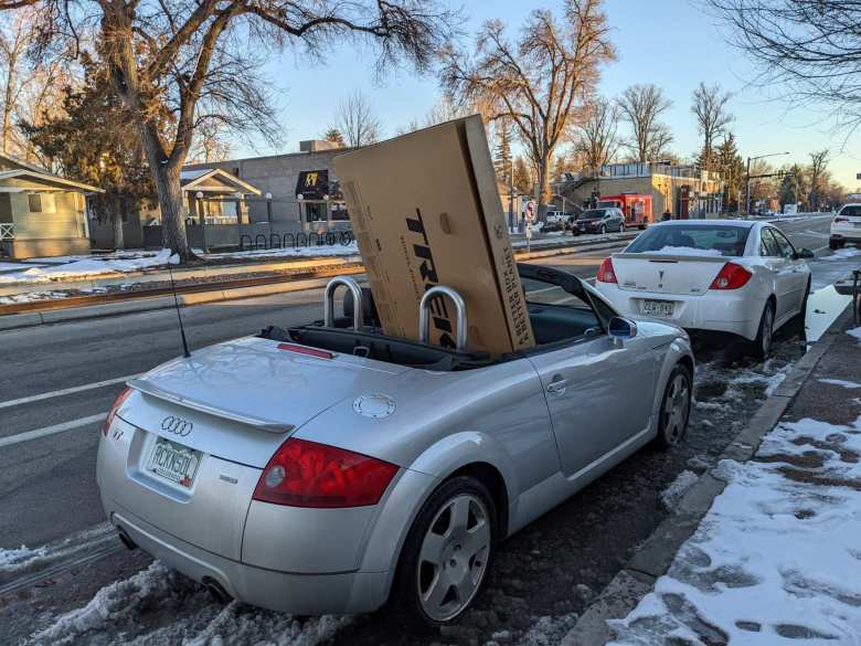 Picking up a cardboard bicycle box in downtown Fort Collins with an Audi TT Roadster.