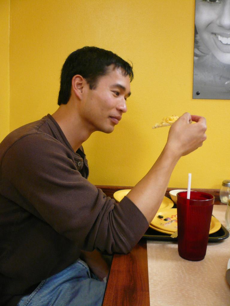 Felix Wong trying the macaroni and cheese pizza.